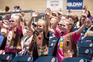 Girl Scout Brownies cheering together at a sporting event